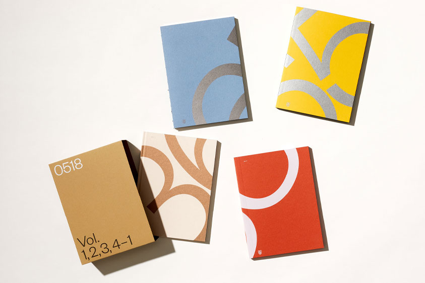 The 2022 Fedrigoni brochure with the different volumes scattered out of the cover.