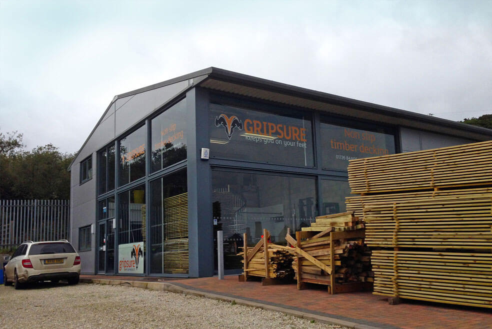 Gripsure's warehouse with printed window stickers of logos and text that is designed by Oracle design.