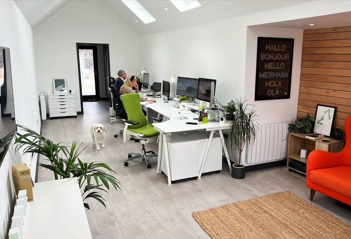 The Oracle Design Studio with people working at there desks and a dog