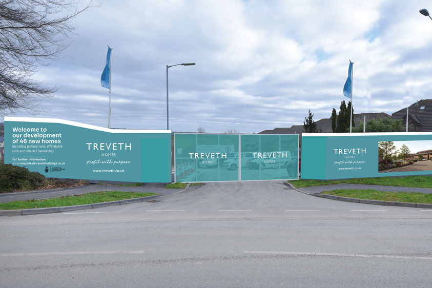 A photo of Treveth Hoarding and flags at a property site that had been designed by Oracle Design
